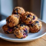 Pile of freshly baked Apple Blueberry Dog Bites on a white plate, ready to be served.