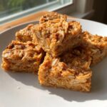 Close-up of homemade Chicken and Rice Dog Treats on a white plate, ready to serve.