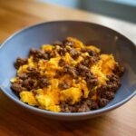 A bowl of Ground Beef and Egg Mix DOG RECIPE, a simple meal for your furry friend.