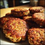 Close-up of freshly cooked Lamb & Oat Burgers – Recipe for Dogs, showing golden-brown patties.