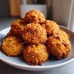 A pile of homemade Peanut Butter Chicken Broth Dog Treats on a gray plate, ready to be served.
