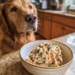 Golden retriever looks longingly at a bowl of Salmon & Spinach Dog Recipe, ready to be eaten.