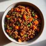 A bowl of homemade Vegan Dog Food Recipe featuring lentils, carrots, and peas. Nutritious and delicious!