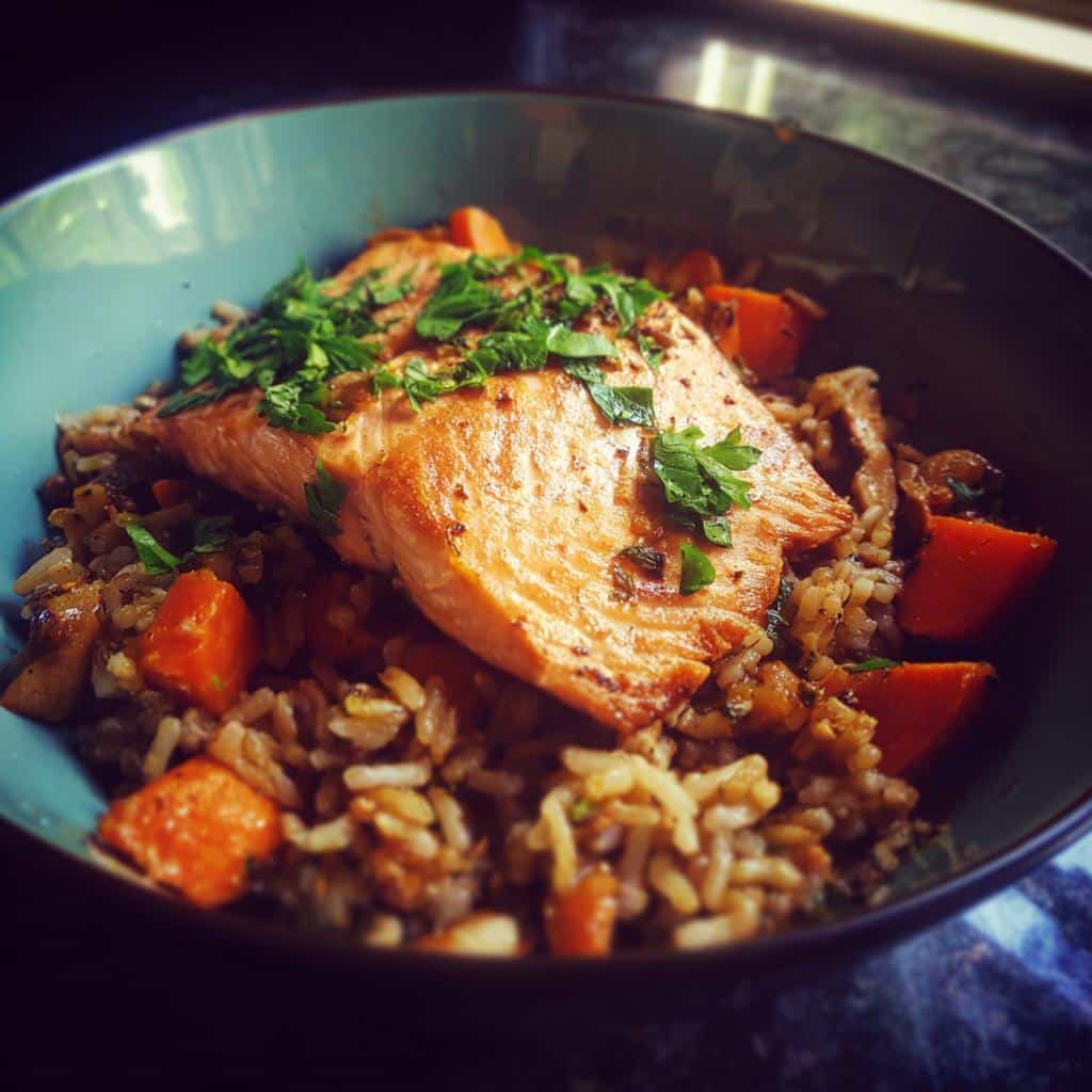 A bowl of Favorite Salmon & Brown Rice Dog Meal, topped with fresh parsley.
