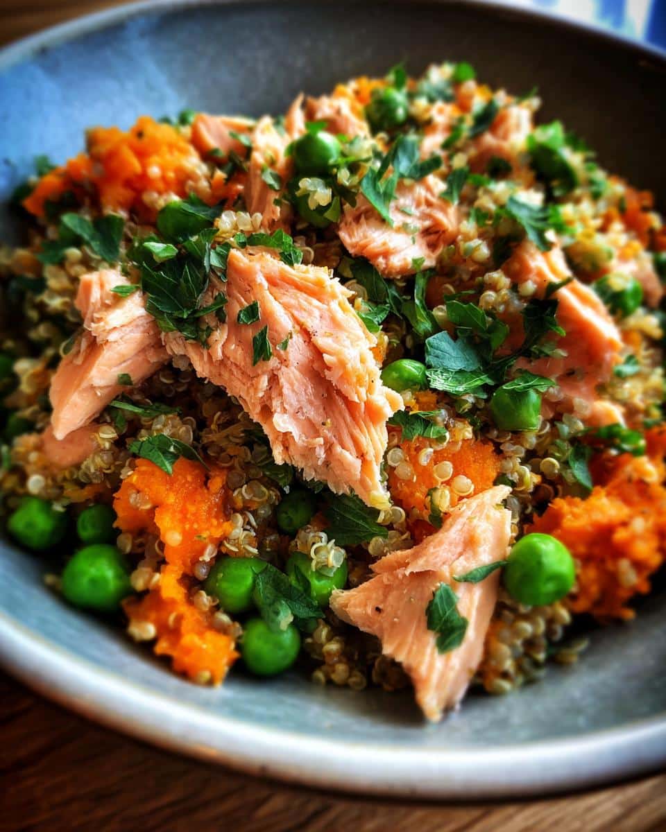 A delicious and nutritious Salmon & Quinoa Dog Energy Bowl with peas, carrots, and parsley.