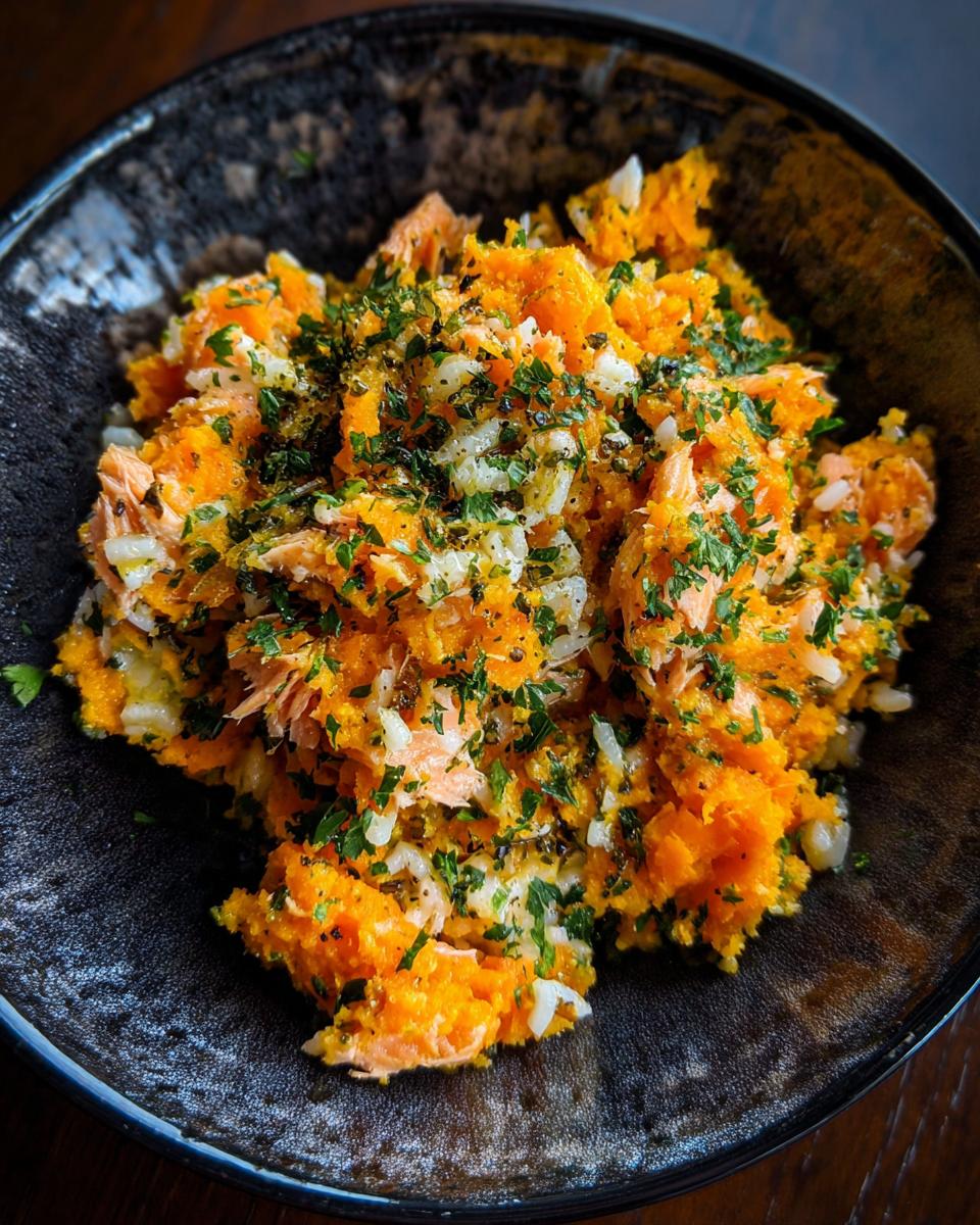 A bowl of homemade Sweet Potato & Salmon Digestive Dog Food, garnished with herbs.