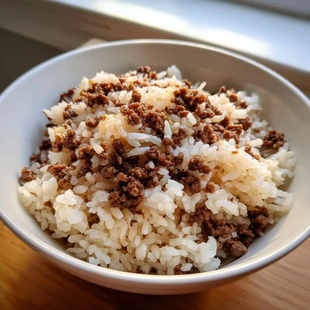 Close-up of a white bowl filled with white rice topped generously with seasoned ground beef for a Beef Rice Routine Dog Meal.