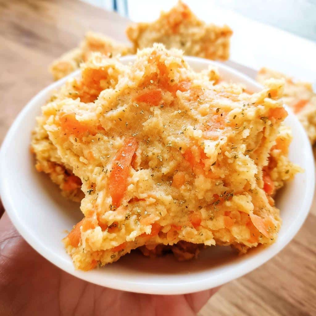 Close-up of star-shaped Lentil Veggie Mash for Seniors, featuring visible shredded carrots and herbs.