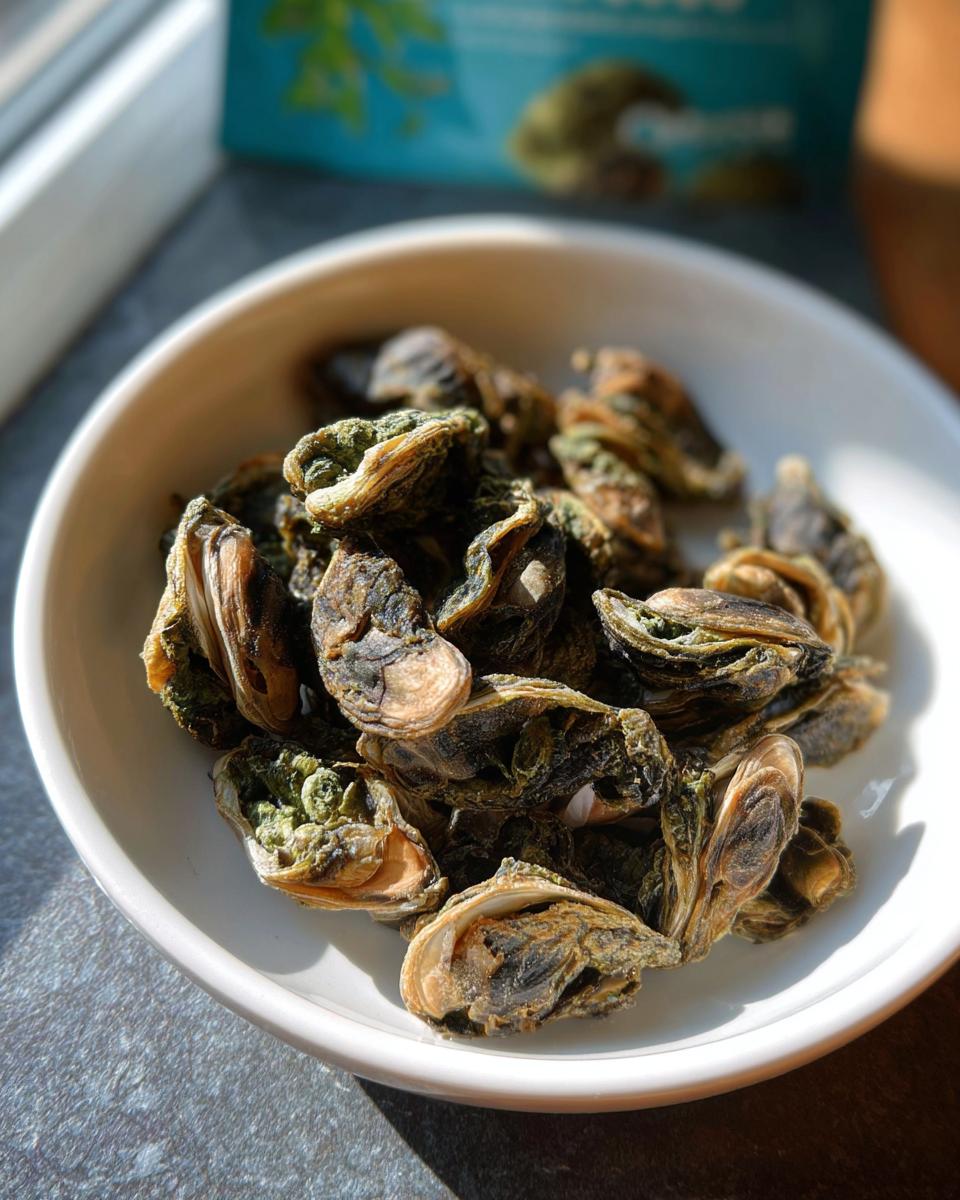 Close-up of dried Green Lipped Mussel Bites in a small white bowl, likely a pet treat.
