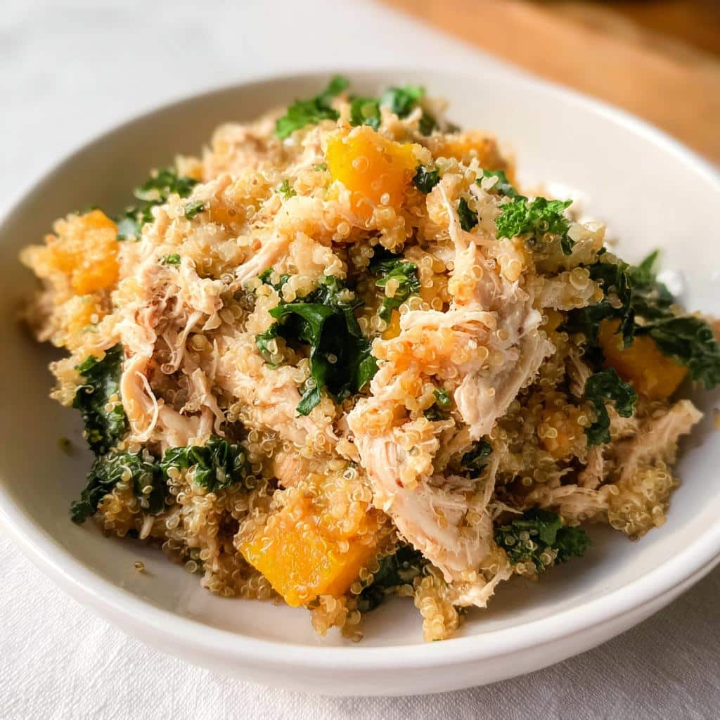 Close-up of Chicken, Quinoa & Spinach Mini-Batch Dog Food mixture served in a white bowl.
