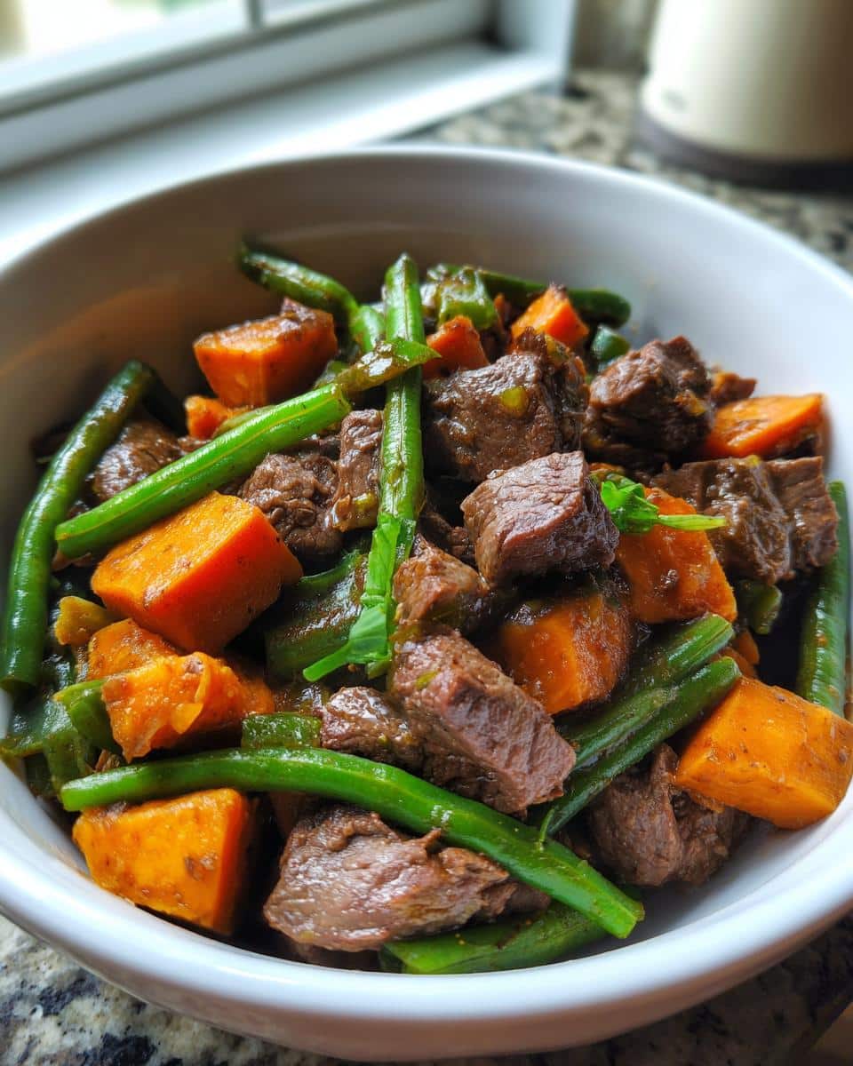 Close-up of homemade March Beef Heart, Sweet Potato & Green Beans Dog Food in a white bowl.