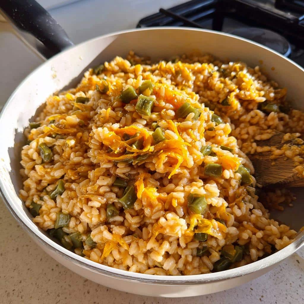 Close-up of cooked barley mixed with shredded orange vegetables and green beans, resembling Venison, Barley & Green Beans Dog Food.