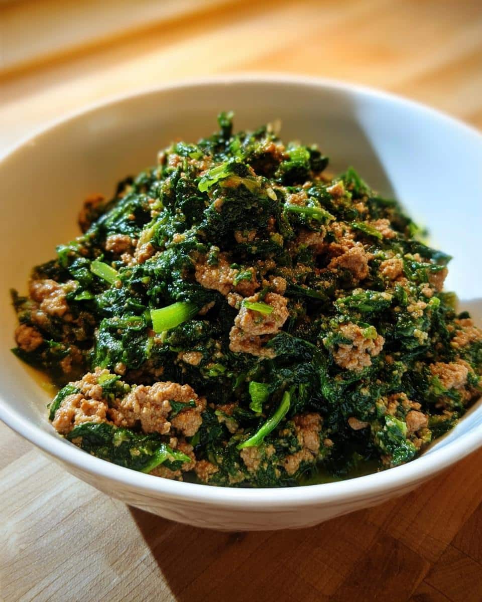 Close-up of homemade Venison, Millet & Spinach Dog Food mixture in a white bowl.