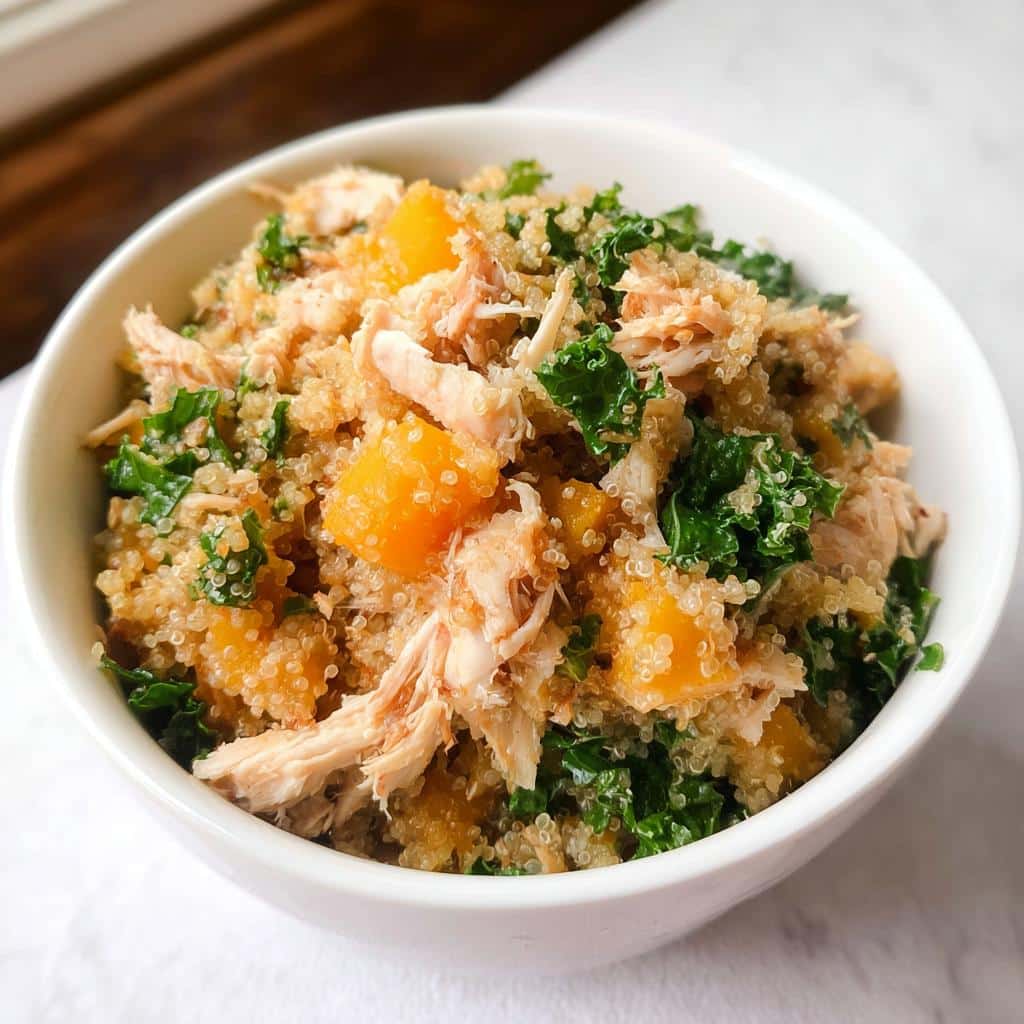 Close-up of Vet-Approved Chicken, Quinoa & Spinach Dog Food in a white bowl.